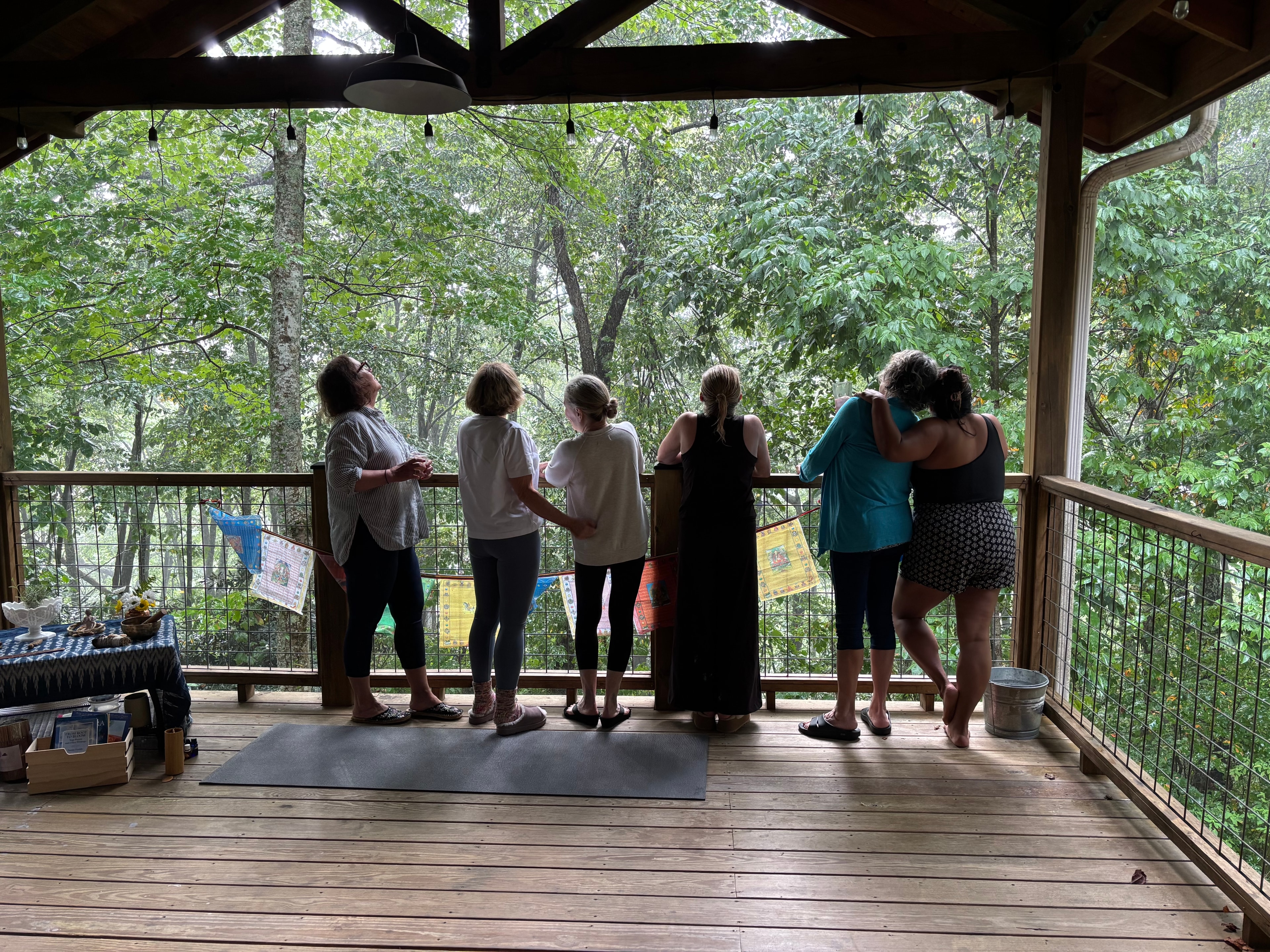 Retreat guests gathering on the forest deck